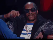 Snoop Dogg lifts sunglasses