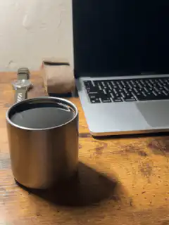 coffee cup next to laptop