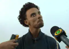 Man looking confused at microphones