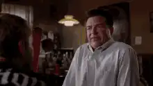 John Goodman grimacing in a room