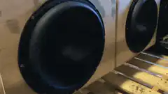 subwoofer vibrating in wooden box