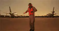 Airport ground crew dancing with wands