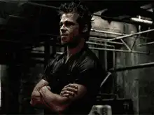 Ryan Reynolds smirking with arms crossed