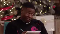 Tyler Perry writing on notepad Christmas