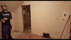 Man smashes wall with hammer