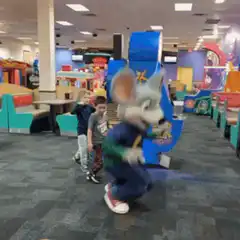 Chuck E. Cheese mascot dancing