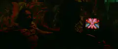 Two men watching psychedelic TV