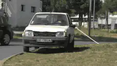 White car with long pole attached
