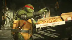 Raphael takes a slice of pizza