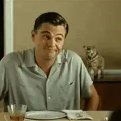 Leonardo DiCaprio smirking at dinner