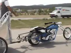 Man riding motorcycle pulling a trailer