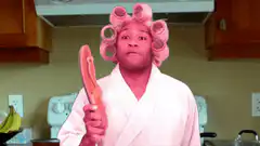 Man in pink robe and curlers holding a flip flop