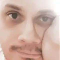 Man resting cheek on hand