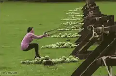 woman swings bat at watermelons