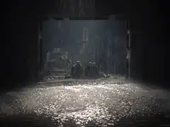 Three figures sitting in a flooded tunnel