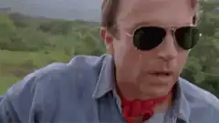 Man removes sunglasses to reveal wire glasses