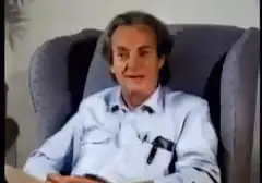 Richard Feynman talking in a chair