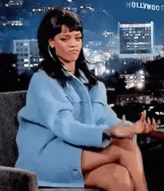 Rihanna clapping with a skeptical look