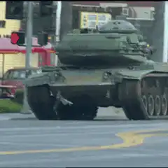 Tank crashes through traffic light pole