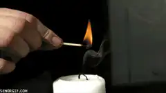 Hand lighting a candle with a match