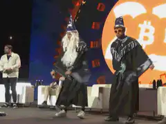 Two men in wizard costumes dancing on stage