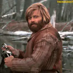 Dude holding a gun smirking