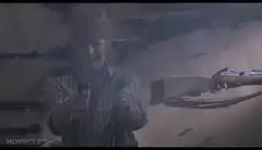 Man firing two pistols in a shooting range