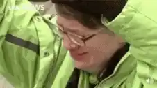 Man in green jacket crying and screaming