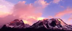 Pink and purple sunset over snowy mountains