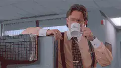 Dwight Schrute sips coffee and makes a face