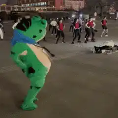 green dinosaur mascot dancing