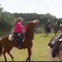 Woman falls off bucking horse