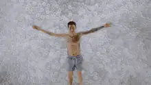 Man making snow angel in bubble wrap