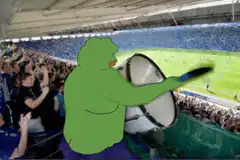 green blob playing drum in stadium