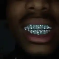 Man with diamond grills and sunglasses