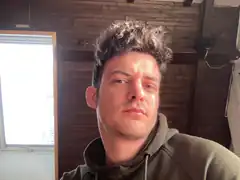 Man with messy hair in hoodie