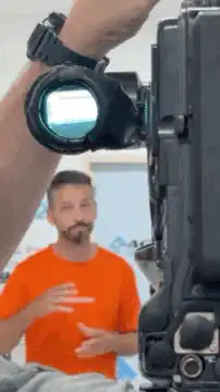 Cameraman adjusting camera viewfinder
