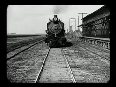 Train approaching with purple bird head