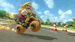 Wario driving a monster truck kart