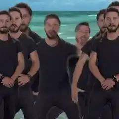 Group of men dancing on a beach