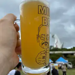 Hand holding a beer mug with cartoon man