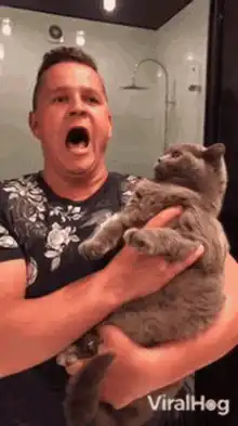 Man screaming while holding a cat