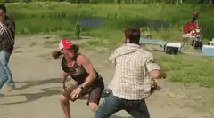 woman in red hat dodging zombie attack