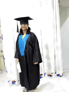 Woman in graduation gown dancing