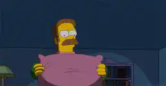 Homer Simpson hugging a pillow