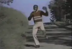 Man dancing on sidewalk