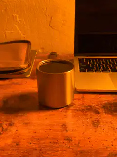 coffee mug on desk with laptop