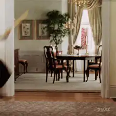 Woman sweeping floor with broom