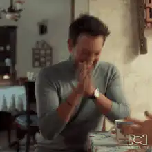 Man covers face then smiles