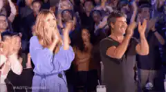 Simon Cowell and Nicole Scherzinger applauding